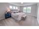 Tranquil bedroom with plush carpet, natural light from three windows, and a comfortable upholstered headboard at 124 Sugar Run Dr # 11, Fuquay Varina, NC 27526