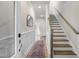 Inviting foyer with wainscoting, a staircase, and an accent mirror for added appeal at 124 Sugar Run Dr # 11, Fuquay Varina, NC 27526