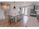 Modern kitchen boasts a large island, stainless steel appliances, and a view to the backyard through French doors at 124 Sugar Run Dr # 11, Fuquay Varina, NC 27526