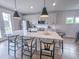 Kitchen island with modern pendant lights, stainless steel appliances, and comfortable seating for casual dining at 124 Sugar Run Dr # 11, Fuquay Varina, NC 27526