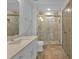 Modern bathroom featuring a glass shower, granite countertop, and sleek white cabinets at 1300 St Marys St # 402, Raleigh, NC 27605
