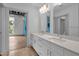 Bathroom featuring double sinks with quartz counters, white cabinets, and tile floors at 1300 St Marys St # 402, Raleigh, NC 27605