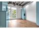 Bedroom with concrete floors, light blue built-in cabinets, and windows with green tree view at 1300 St Marys St # 402, Raleigh, NC 27605