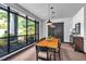 Cozy dining room with large windows, a wooden table, and modern pendant lighting at 1300 St Marys St # 402, Raleigh, NC 27605