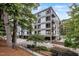 Modern condo building with balconies and parking located in a beautiful wooded area at 1300 St Marys St # 402, Raleigh, NC 27605