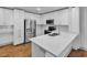 Modern kitchen with stainless steel appliances, white cabinets, and white quartz countertop island at 1300 St Marys St # 402, Raleigh, NC 27605