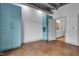 Living room featuring concrete-look floors, light blue cabinets, and view into bathroom at 1300 St Marys St # 402, Raleigh, NC 27605