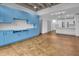 Open-concept living space featuring custom light blue built-in cabinetry and concrete-look floors at 1300 St Marys St # 402, Raleigh, NC 27605