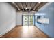 Open living space with exposed ceiling, stained concrete floors, and built-in blue storage cabinets at 1300 St Marys St # 402, Raleigh, NC 27605