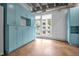 Bright living space with exposed ceiling, stained concrete floors, and built-in blue storage cabinets at 1300 St Marys St # 402, Raleigh, NC 27605