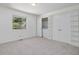 Bedroom featuring neutral carpet, a window, and a closet with washer/dryer at 152 A&B Cedar Terrace, Chapel Hill, NC 27516
