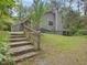 Charming gray home featuring stone steps, green lawn, mature trees, and a deck at 152 A&B Cedar Terrace, Chapel Hill, NC 27516