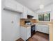 Bright kitchen featuring white cabinets and modern black appliances at 152 A&B Cedar Terrace, Chapel Hill, NC 27516