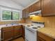 Kitchen with wood cabinets, laminate countertops, and white appliances at 152 A&B Cedar Terrace, Chapel Hill, NC 27516
