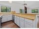 Kitchen featuring white cabinets, a breakfast bar, and modern appliances at 152 A&B Cedar Terrace, Chapel Hill, NC 27516