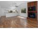Bright living room featuring a fireplace, ceiling fan, and backyard view at 152 A&B Cedar Terrace, Chapel Hill, NC 27516