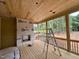Covered back porch features wood ceilings and floors, as well as a stone fireplace at 155 Cherry Bark Dr, Youngsville, NC 27596