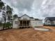 Exterior elevation of home under construction with white siding and covered deck at 155 Cherry Bark Dr, Youngsville, NC 27596