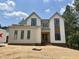 New construction two-story home with white siding, black trim, and an unfinished front yard at 155 Cherry Bark Dr, Youngsville, NC 27596