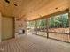 Covered porch shows a fireplace, wood ceiling, and outdoor views at 155 Cherry Bark Dr, Youngsville, NC 27596