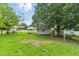 Backyard shot of shed and a one-story home at 16 S Church, Coats, NC 27521