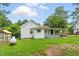 View of a one-story home, with covered porch, fence, and gas tank at 16 S Church, Coats, NC 27521