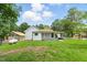 View of a one-story home, with covered porch, fence, and gas tank at 16 S Church, Coats, NC 27521