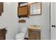 Bathroom with decorative sink, toilet, and wooden storage at 16 S Church, Coats, NC 27521