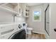 Modern bathroom features a convenient washer/dryer, shower, and built in shelving at 16 S Church, Coats, NC 27521