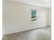 Bright bedroom features a window, neutral walls, and vinyl flooring at 16 S Church, Coats, NC 27521