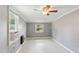 Bedroom with ceiling fan, gray walls, two windows, and climate control at 16 S Church, Coats, NC 27521