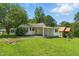 Charming one-story home featuring a covered porch, well-maintained lawn, and lovely landscaped surroundings at 16 S Church, Coats, NC 27521
