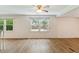 Bright living room with hardwood floors, ample natural light, and a ceiling fan at 16 S Church, Coats, NC 27521