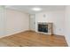 Cozy living room featuring hardwood floors, a stone fireplace, and neutral paint at 16 S Church, Coats, NC 27521