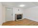 Cozy living room featuring hardwood floors, a stone fireplace, and neutral paint at 16 S Church, Coats, NC 27521