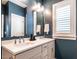 Modern bathroom features a double vanity and white cabinets at 1610 Draper View Loop # 101, Raleigh, NC 27608