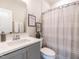 Stylish bathroom with gray vanity, framed art, and a shower with a curtain at 1610 Draper View Loop # 101, Raleigh, NC 27608
