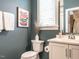 Cozy bathroom features modern fixtures, colorful wall art, and white cabinets at 1610 Draper View Loop # 101, Raleigh, NC 27608