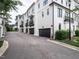 Modern townhomes with black accents, garages, and manicured landscaping at 1610 Draper View Loop # 101, Raleigh, NC 27608