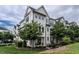 Beautiful white townhome featuring black trim, multiple windows and professionally landscaped yard at 1610 Draper View Loop # 101, Raleigh, NC 27608