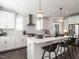 Bright kitchen featuring a center island with seating, modern pendant lighting, and stainless steel appliances at 1610 Draper View Loop # 101, Raleigh, NC 27608