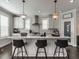 Bright kitchen with quartz countertops, subway tile backsplash, stainless vent hood and modern pendant lighting at 1610 Draper View Loop # 101, Raleigh, NC 27608