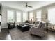 Bright living room with a large sofa, stylish chairs, plantation shutters and ceiling fan at 1610 Draper View Loop # 101, Raleigh, NC 27608