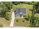 Aerial view of a two-story home showcasing its well-manicured landscaping, long driveway, and roof at 1625 Banks View Dr, Raleigh, NC 27603