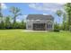 Backyard featuring a screened porch, a large grassy yard, and mature trees at 1625 Banks View Dr, Raleigh, NC 27603