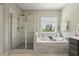 Beautiful bathroom with glass shower and soaking tub with natural light at 1625 Banks View Dr, Raleigh, NC 27603