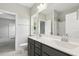 Bright bathroom featuring a double vanity, shower and tub, with natural light from a window at 1625 Banks View Dr, Raleigh, NC 27603