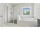Beautiful bathroom with marble, a glass shower, and soaking tub by the window at 1625 Banks View Dr, Raleigh, NC 27603