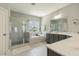 Elegant bathroom featuring a glass-enclosed shower, soaking tub, and double vanity at 1625 Banks View Dr, Raleigh, NC 27603