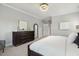 Spacious bedroom with modern furniture and decor, including a dresser and full-length mirror at 1625 Banks View Dr, Raleigh, NC 27603